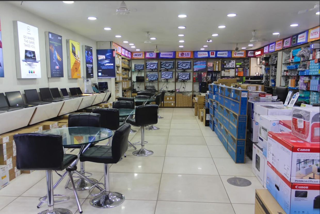 Curated laptop wall inside Kalptaru Computers with Dell, HP, ASUS and Lenovo units on display