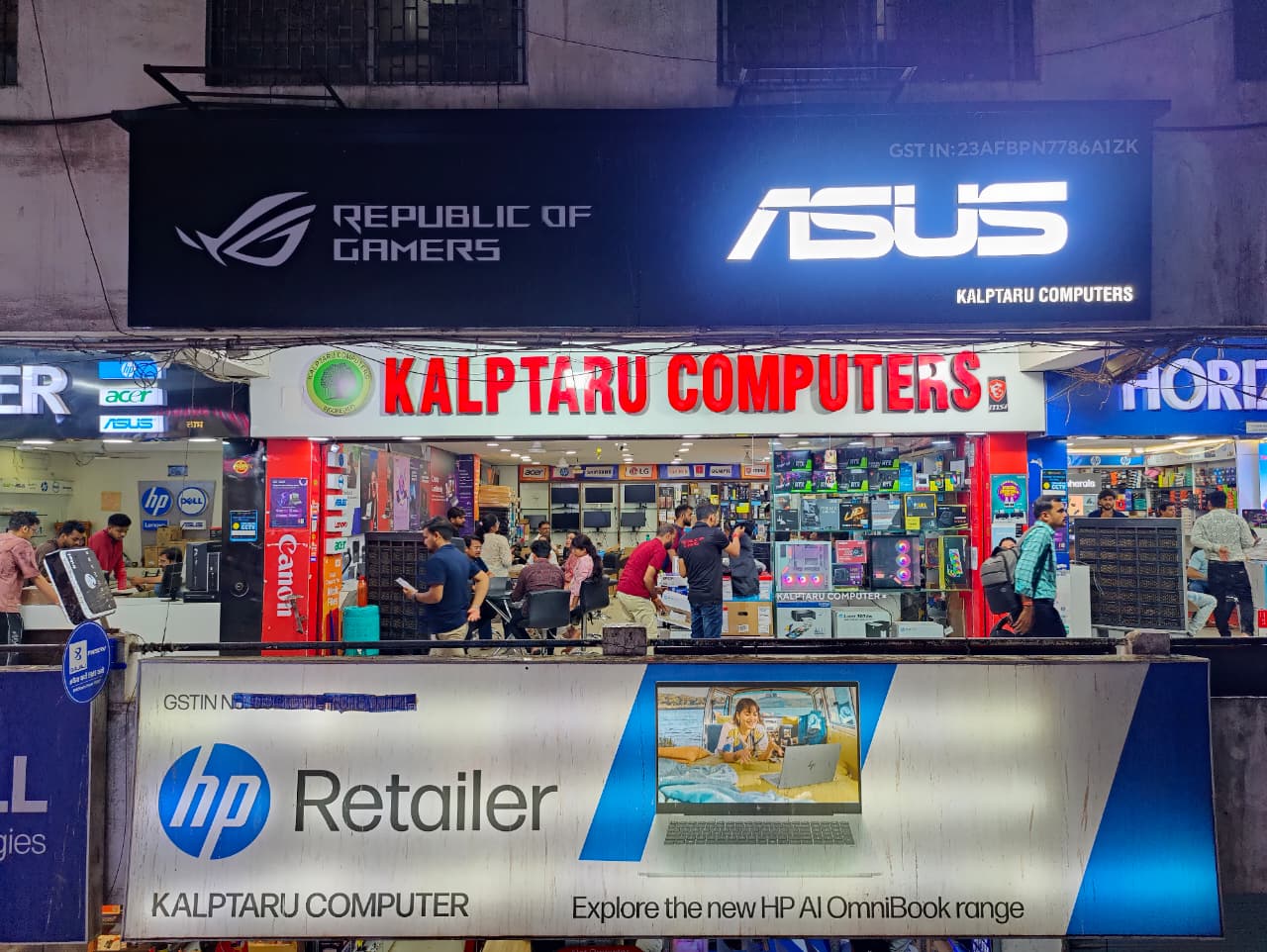 Kalptaru Computers storefront in Indore at night with ASUS ROG and MSI signage