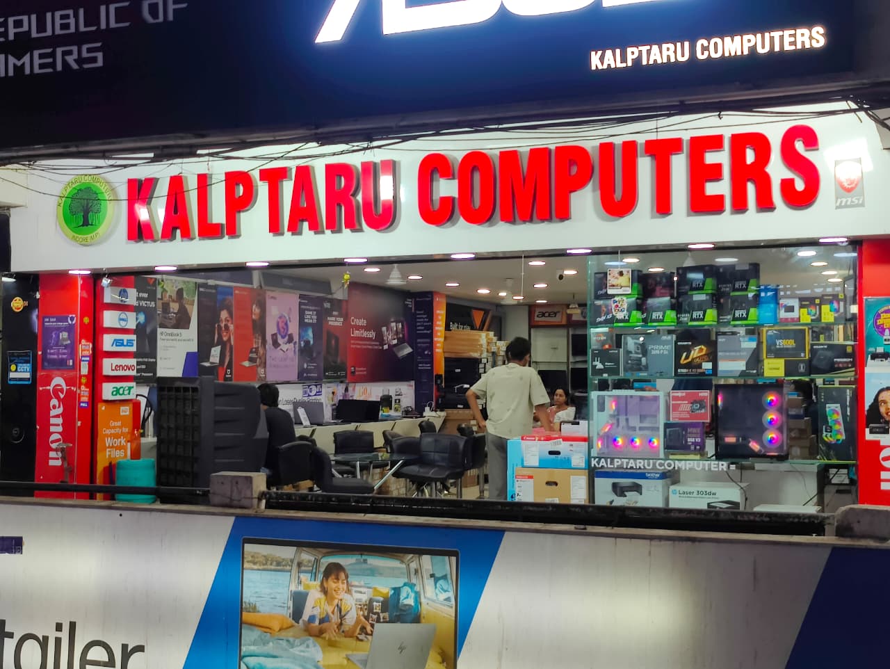 Inside the Kalptaru Computers showroom with laptop displays and glass cabinets